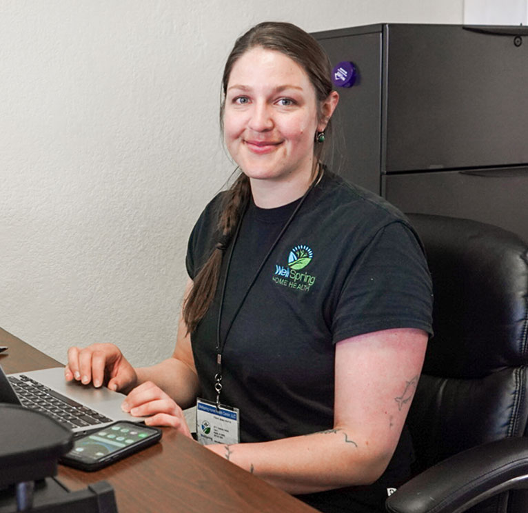 WellSpring Home Health employee works at her desk.
